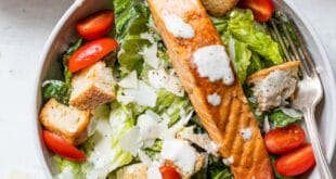 Fresh Caesar salad with grilled salmon, parmesan, and creamy dressing