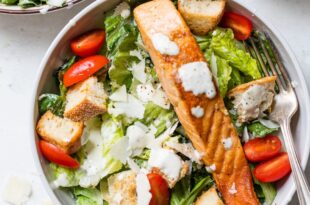 Fresh Caesar salad with grilled salmon, parmesan, and creamy dressing