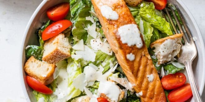 Fresh Caesar salad with grilled salmon, parmesan, and creamy dressing