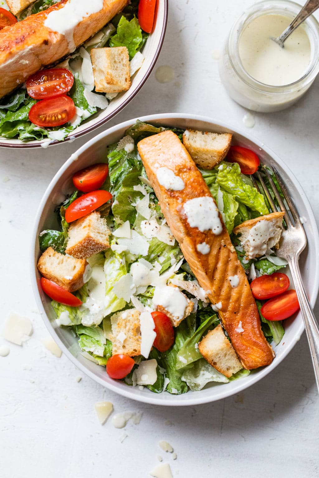 Fresh Caesar salad with grilled salmon, parmesan, and creamy dressing
