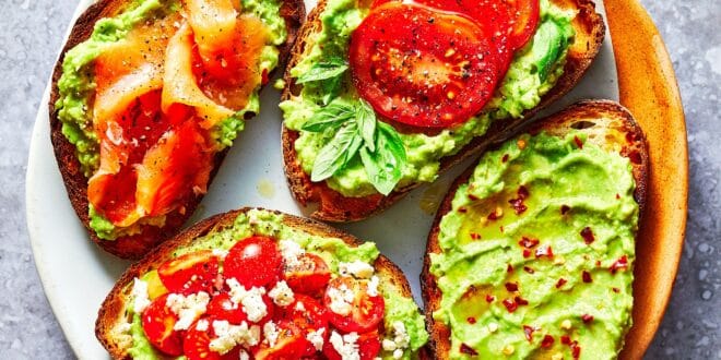 Creamy avocado toast with poached egg, chili flakes, and lemon zest