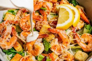 Fresh Caesar salad topped with grilled shrimp, parmesan, and croutons