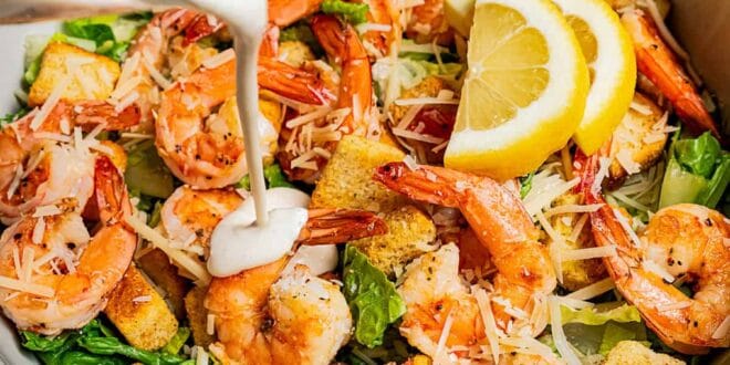 Fresh Caesar salad topped with grilled shrimp, parmesan, and croutons