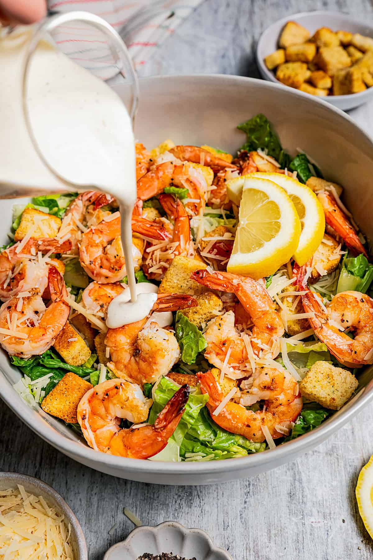 Fresh Caesar salad topped with grilled shrimp, parmesan, and croutons