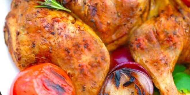 Tender grilled whole chicken served on a platter with herbs