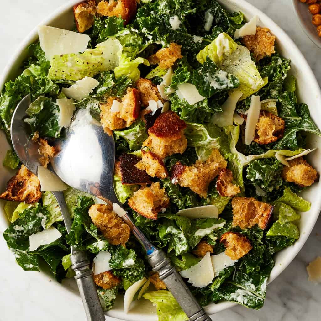 Healthy kale Caesar salad recipe with creamy dressing and parmesan