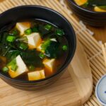 Warm miso soup served with tofu cubes and wakame seaweed