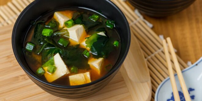 Warm miso soup served with tofu cubes and wakame seaweed