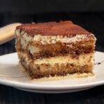 Delicious tiramisu dessert topped with cocoa and cream
